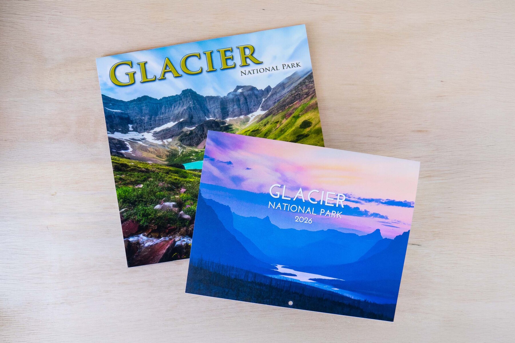 Two calendars on a wood surface
