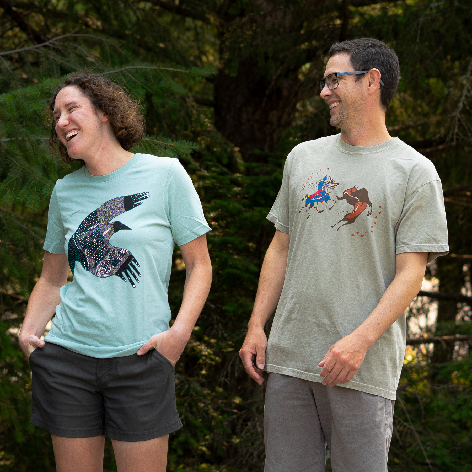 man and woman wearing shirts featuring indigenous art