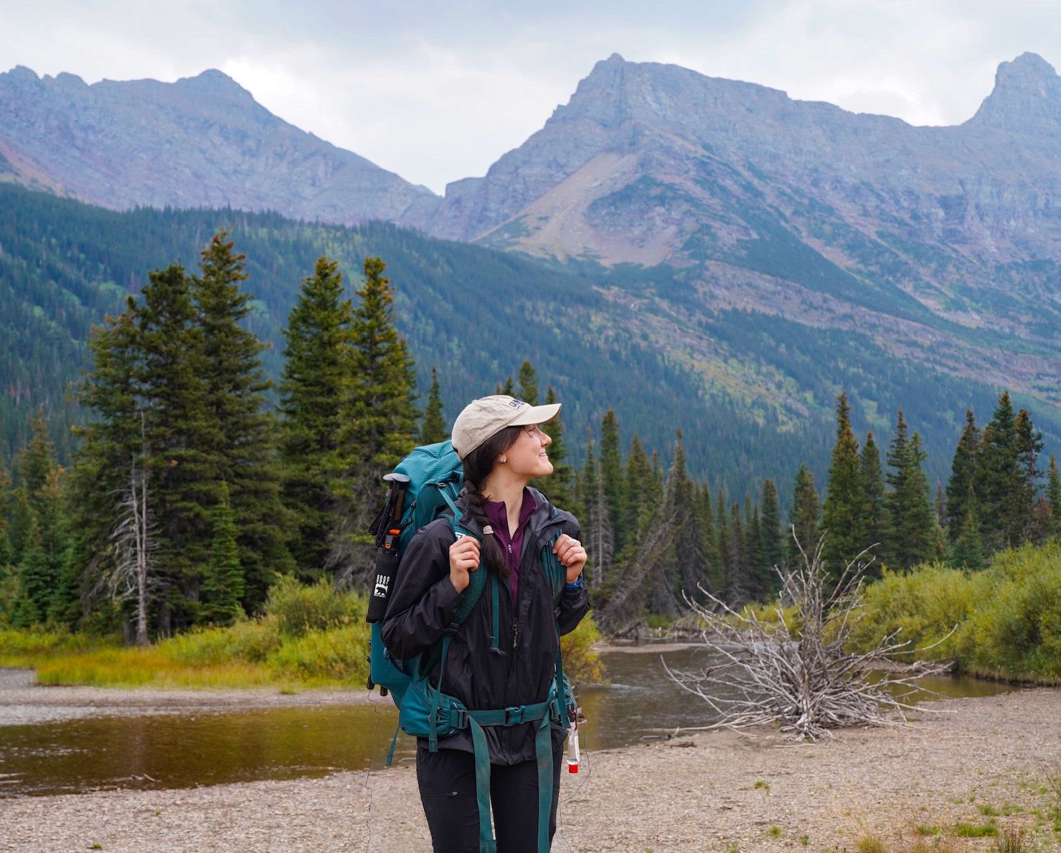 Paige looks up at mountains