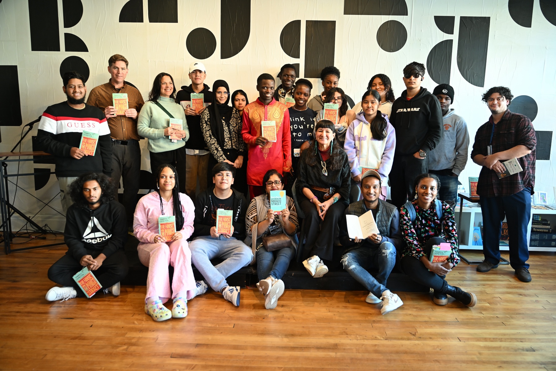 A group of students hold up copies of The House on Mango Street.