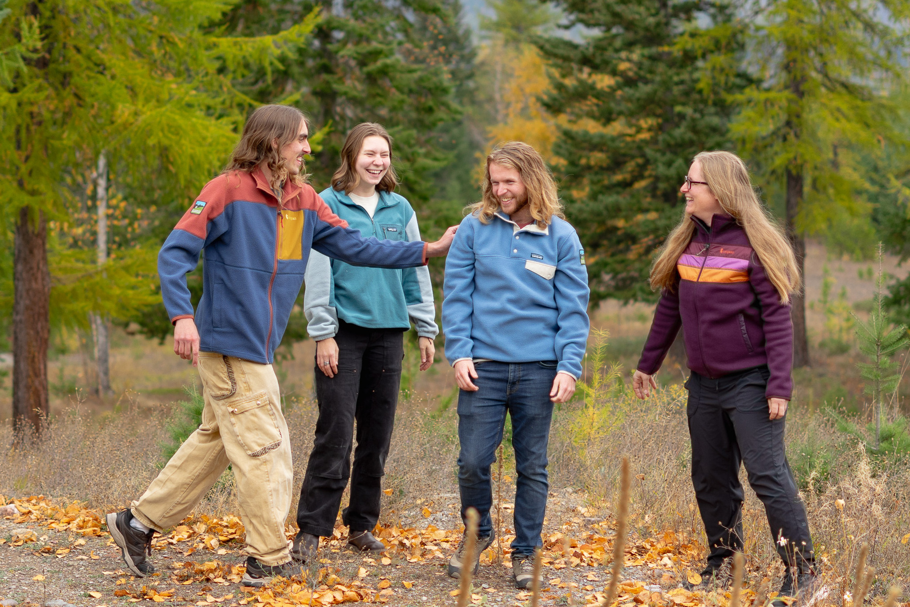 Group of people laughing while wearing Patagonia and Cotopaxi fleece