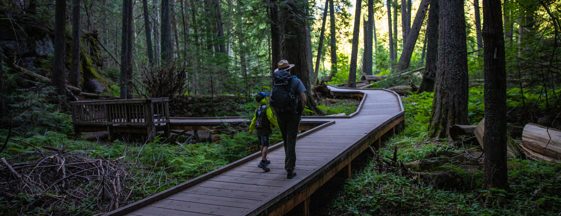 A ranger walking with a child.