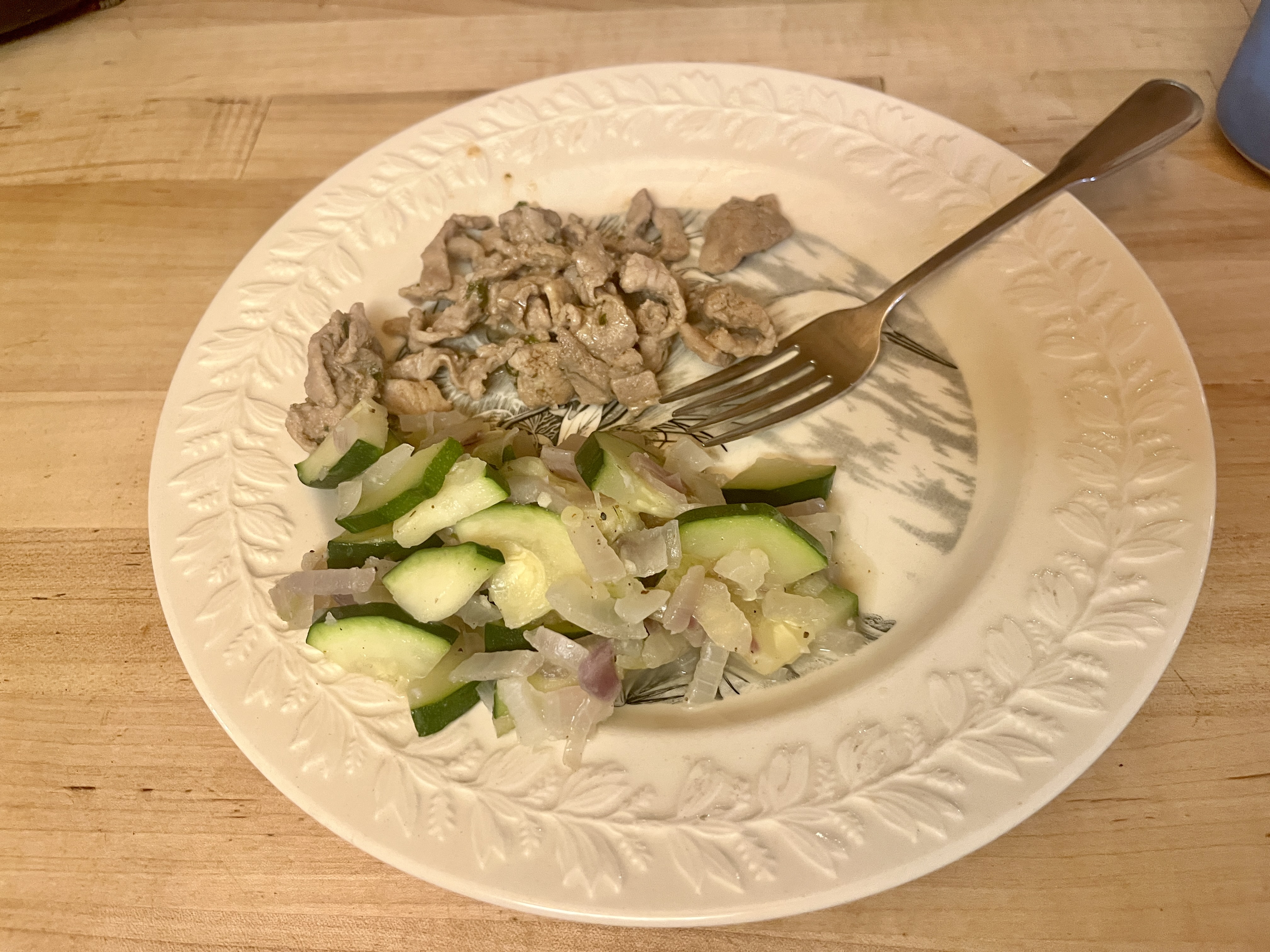 Shaved pork stir fried with zucchini and onion, served over rice