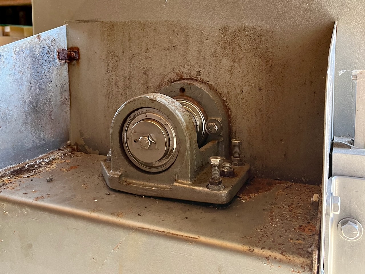 The top bearing on our meat band saw, adjusted to track the blade